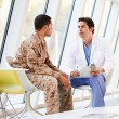 a doctor counseling a soldier at a mental health clinic